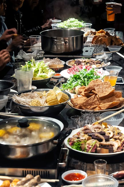 Enjoy a lively communal hot pot feast with fresh ingredients and vibrant flavors, perfect for social dining.